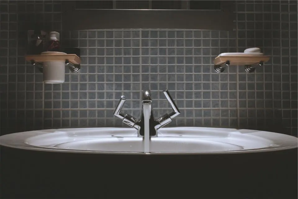 Tiled bathroom sink with a modern faucet