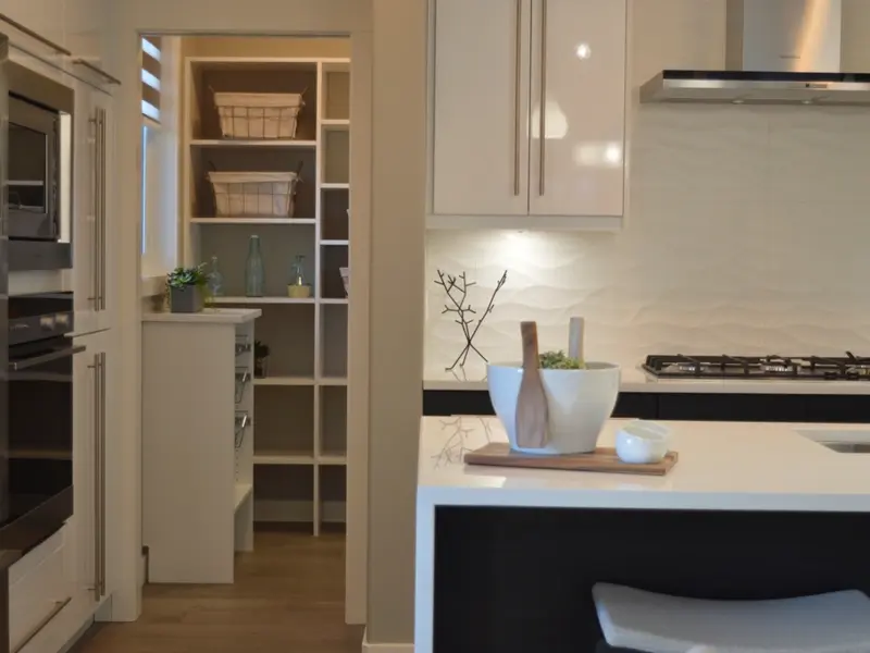 Bright kitchen with a white pantry cabinet and baskets on shelves