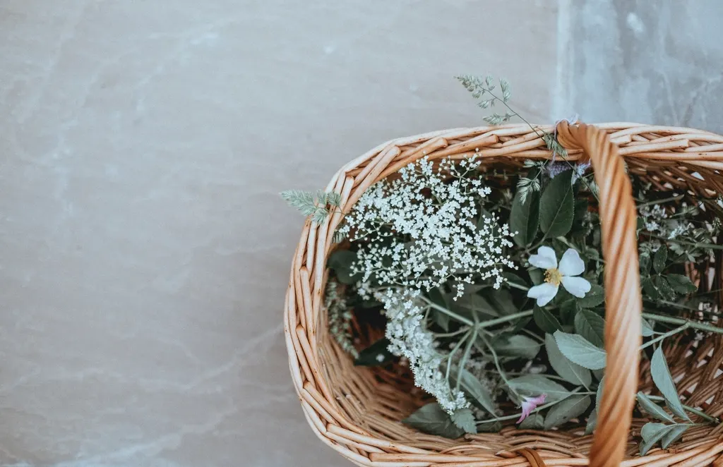 Woven basket holding dried flowers on a light surface